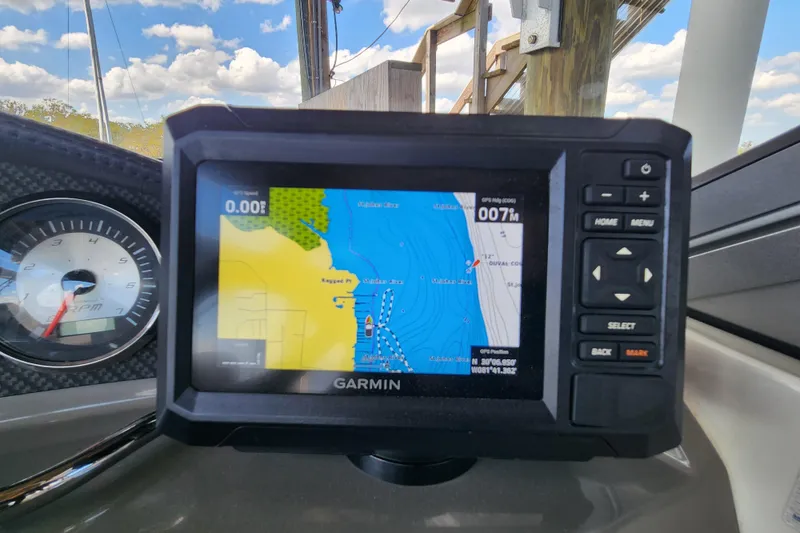 Slide: The Image of Garmin GPS on 2018 Stingray 235 LR boat dashboard, displaying nautical map and speedometer. - 88