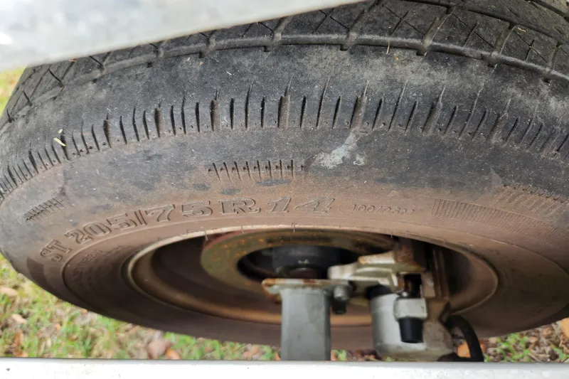 Slide: The Image of Close-up of a 2018 Stingray 235 LR trailer tire, showing tread and rim details. - 94