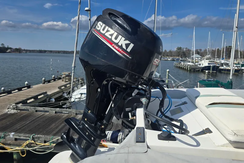 Slide: The Image of Outboard motor on a 1996 President 58 yacht at a marina dock. - 11