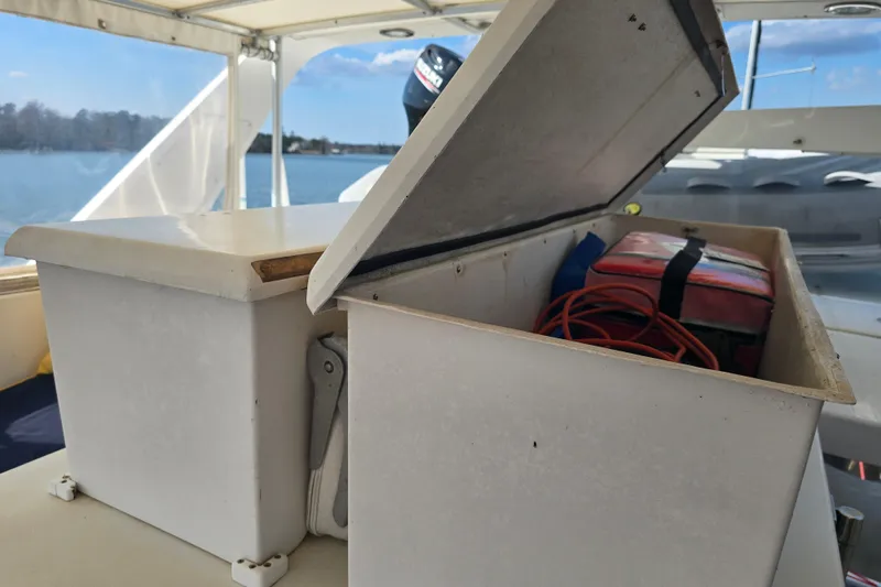 Slide: The Image of Open storage compartment on 1996 President 58 yacht, containing red bag and orange cable. - 13