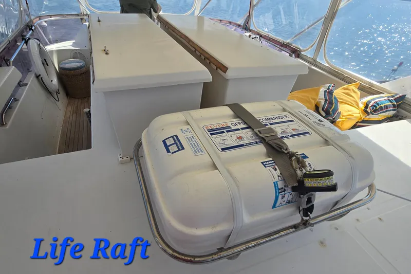 Slide: The Image of Life raft on a 1996 President 58 yacht deck with cushions and ocean view. - 14