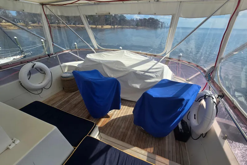 Slide: The Image of 1996 President 58 yacht interior with covered seating and scenic water view. - 15