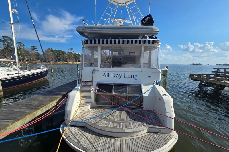 Slide: The Image of Boat named "All Day Long" docked, President 58 model, 1996, on a sunny day. - 2