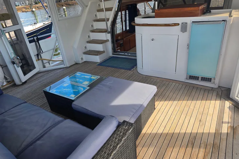 Slide: The Image of Spacious 1996 President 58 yacht interior with wooden flooring and comfortable seating. - 21