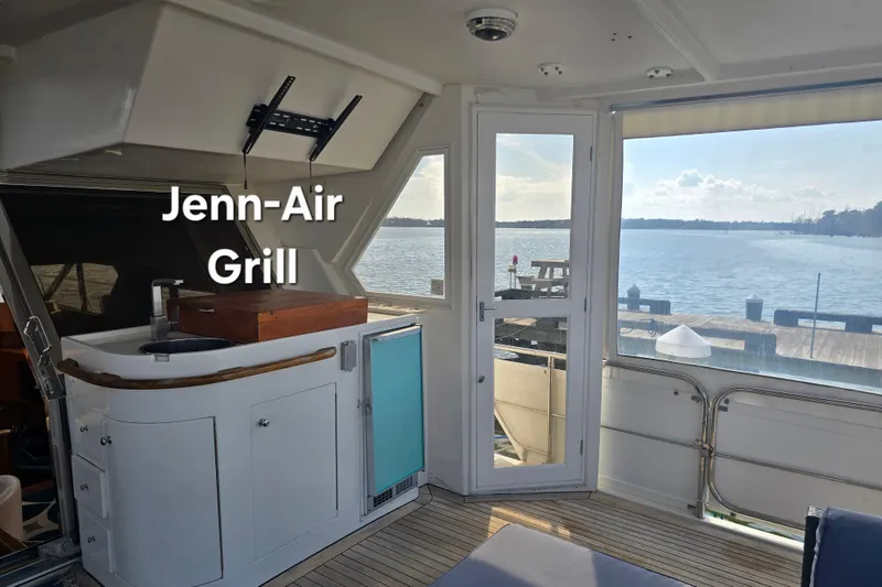 Slide: The Image of Luxurious 1996 President 58 yacht interior with Jenn-Air grill and scenic water view. - 22