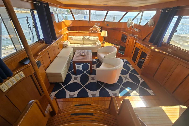 Slide: The Image of Luxurious interior of a 1996 President 58 yacht with elegant wood paneling and plush seating. - 26