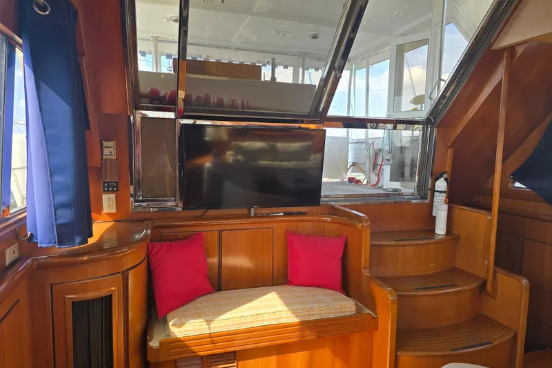 Slide: The Image of Luxurious 1996 President 58 yacht interior with wood paneling, TV, and seating area. - 29