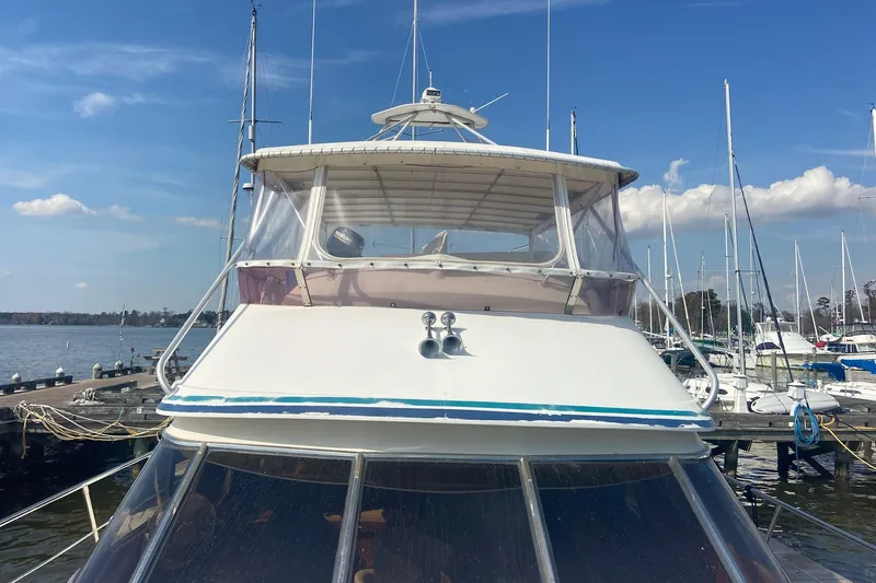 Slide: The Image of 1996 President 58 yacht docked at marina under clear blue sky. - 3