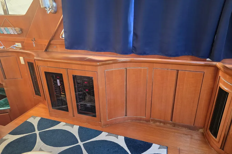 Slide: The Image of Interior of a 1996 President 58 yacht with wooden paneling and control panels. - 31