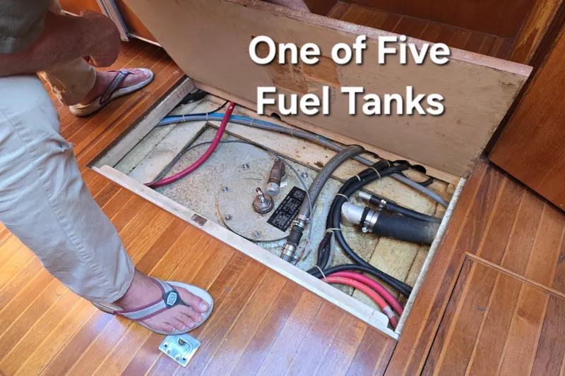 Slide: The Image of 1996 President 58 yacht fuel tank compartment with visible hoses and fittings. - 36