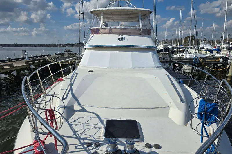 Slide: The Image of Luxury 1996 President 58 yacht docked at marina under blue sky. - 4