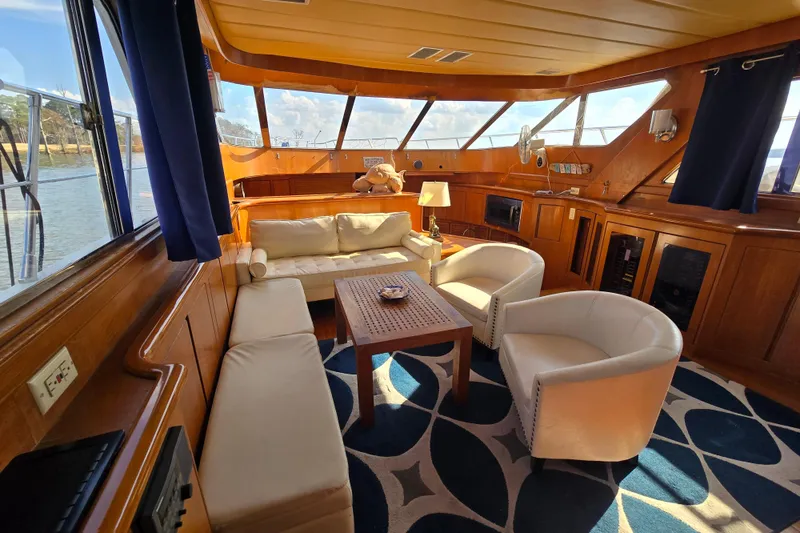Slide: The Image of Luxurious 1996 President 58 yacht interior with elegant seating and panoramic windows. - 44
