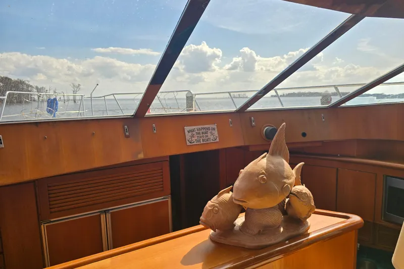 Slide: The Image of Interior of a 1996 President 58 yacht with wooden fish sculpture and scenic view. - 45