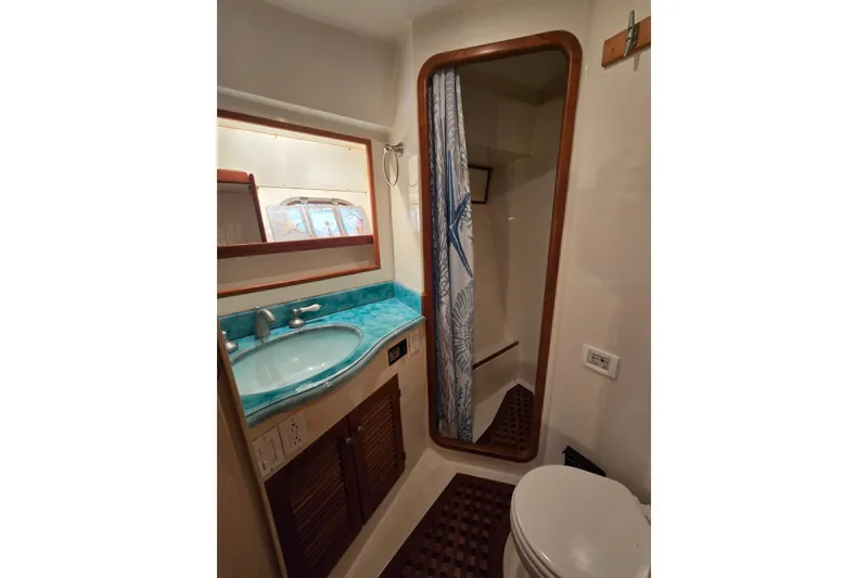Slide: The Image of Bathroom interior of a 1996 President 58 yacht with turquoise countertop and shower. - 51