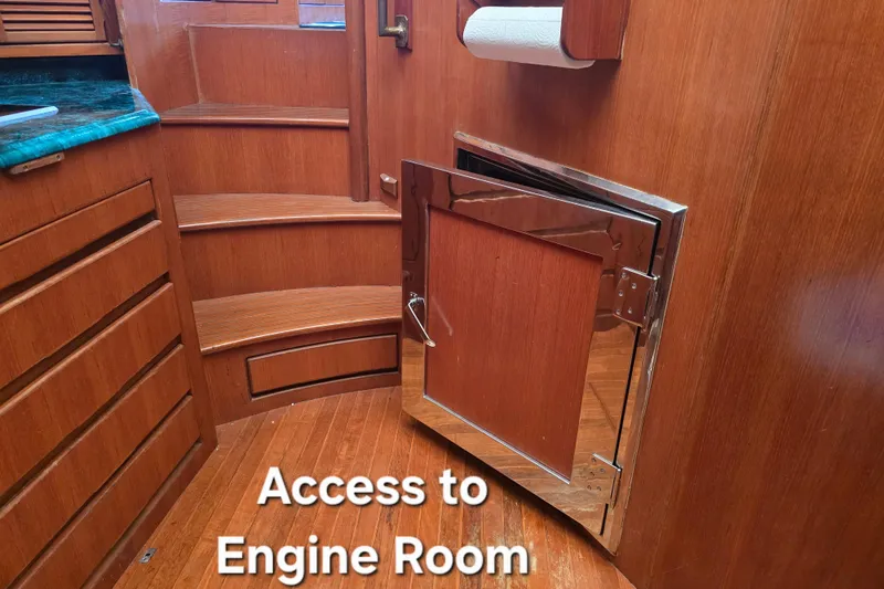Slide: The Image of Access door to engine room on 1996 President 58 yacht, featuring wooden interior. - 55