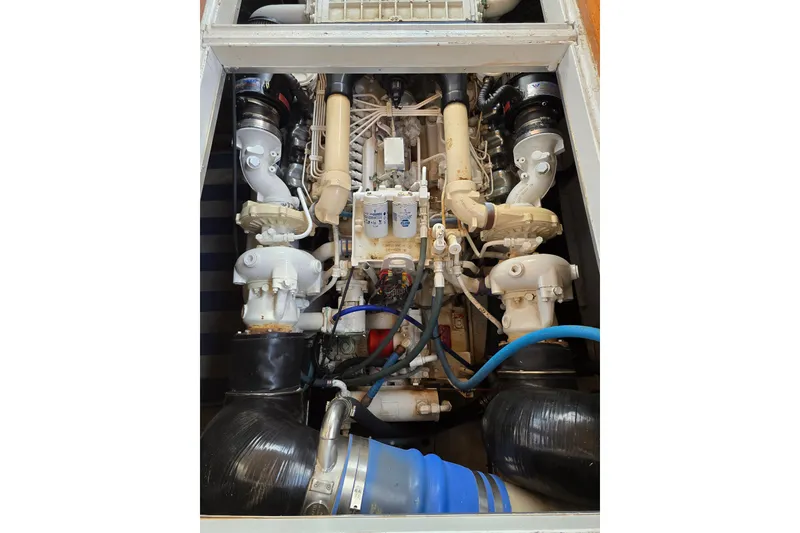 Slide: The Image of Engine compartment of a 1996 President 58 yacht, showcasing intricate mechanical components. - 56