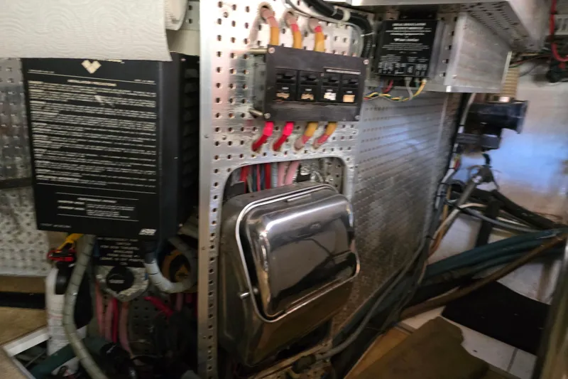 Slide: The Image of Electrical panel in a 1996 President 58 yacht engine room with wiring and components. - 57