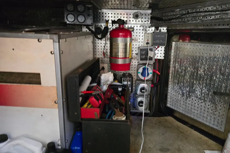 Slide: The Image of Interior of a 1996 President 58 vehicle with tools and fire extinguisher. - 59
