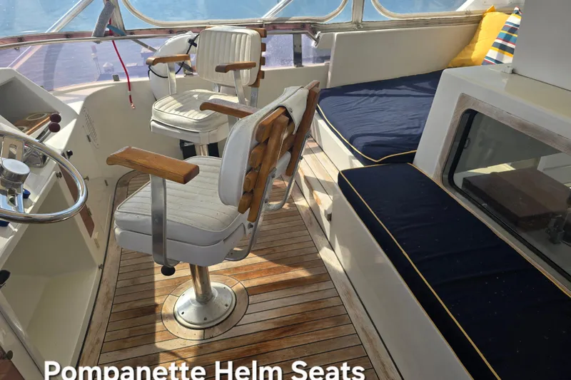 Slide: The Image of Helm seats on a 1996 President 58 yacht with wooden flooring and cushions. - 6