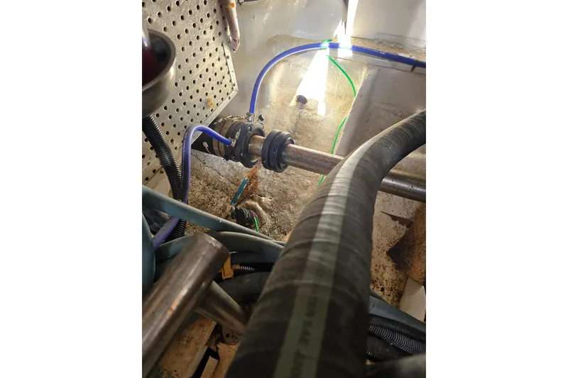 Slide: The Image of Engine compartment of a 1996 President 58 boat with visible hoses and wiring. - 60