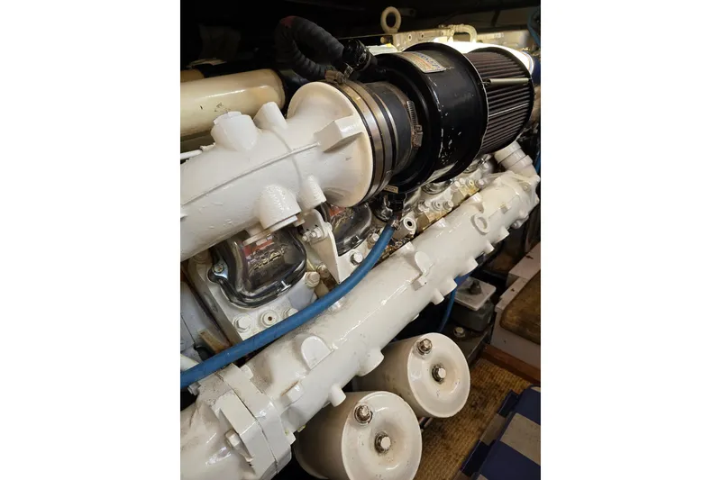 Slide: The Image of Engine of a 1996 President 58 yacht, showcasing detailed mechanical components. - 63