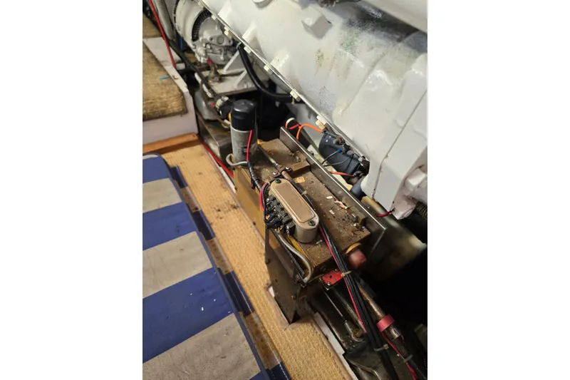 Slide: The Image of Engine compartment of a 1996 President 58 yacht, showcasing mechanical components and wiring. - 64