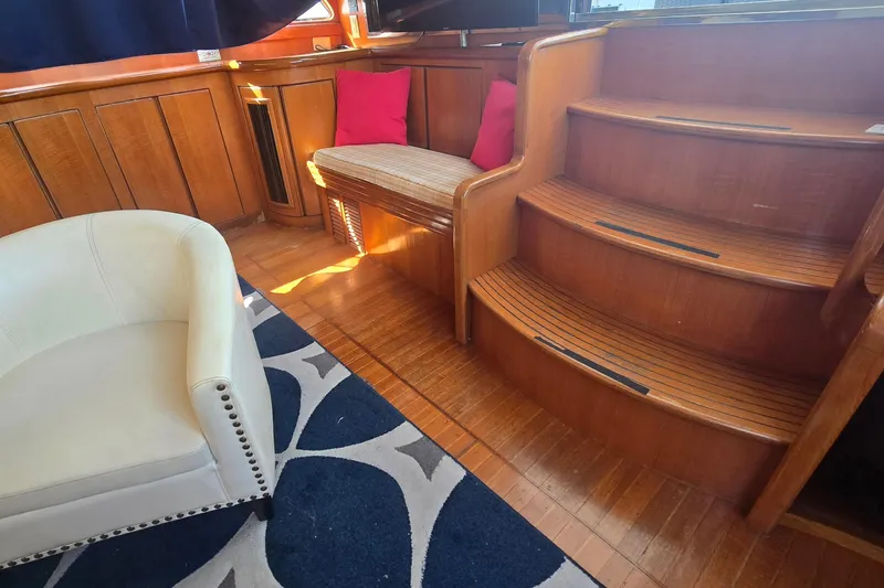Slide: The Image of Luxurious wooden interior of a 1996 President 58 yacht with seating and stairs. - 65