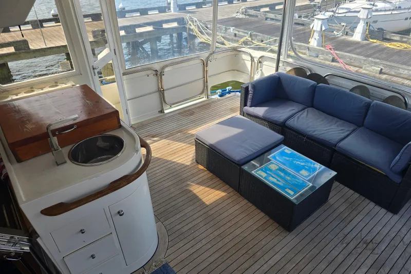 Slide: The Image of Luxurious 1996 President 58 yacht interior with seating area and sink, docked at marina. - 66