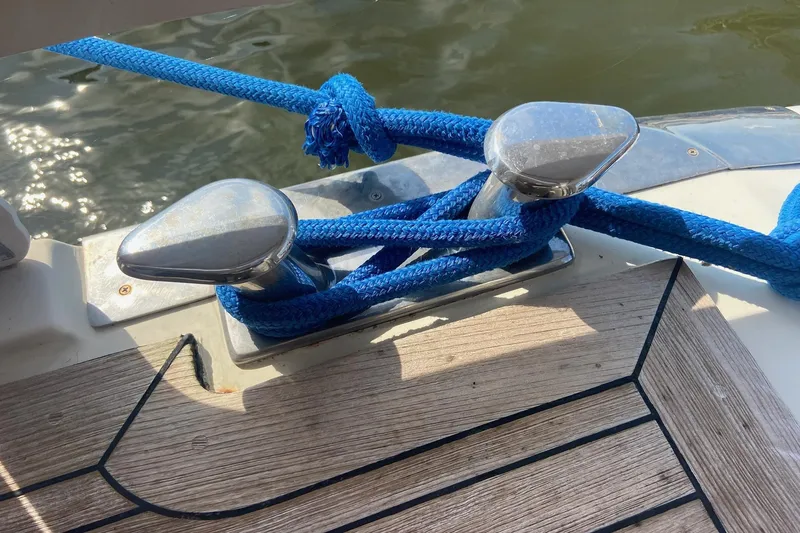 Slide: The Image of Blue rope tied to cleats on a 1996 President 58 boat deck. - 69