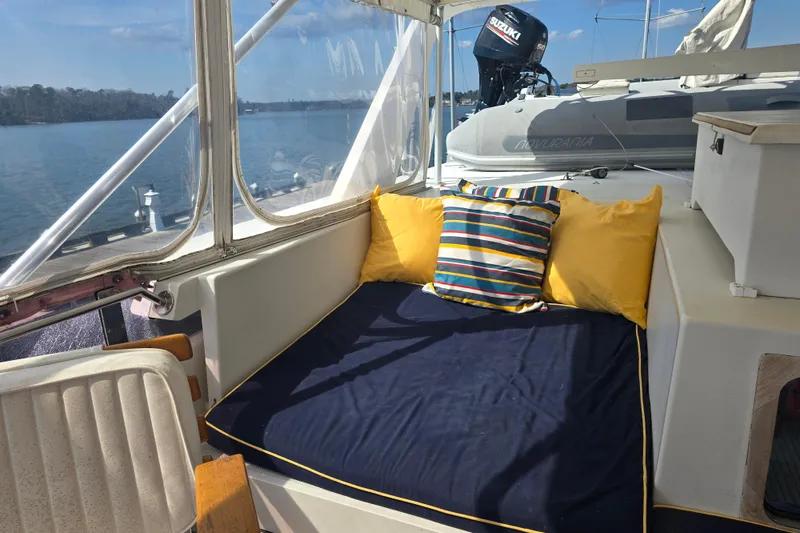 Slide: The Image of Cozy seating area on 1996 President 58 yacht with colorful cushions and scenic water view. - 7