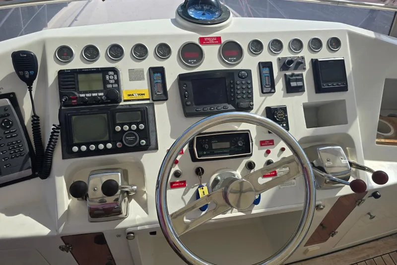 Slide: The Image of Control panel of a 1996 President 58 yacht with navigation instruments and steering wheel. - 8