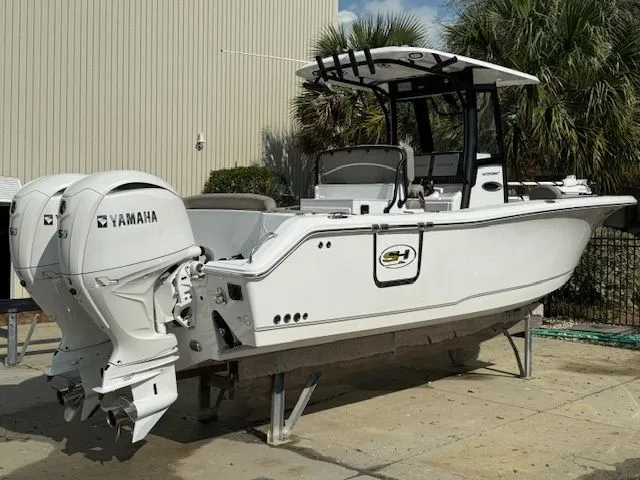 Slide: The Image of 2025 Sea Hunt Ultra 265 SE with Yamaha engines on a dock. - 1