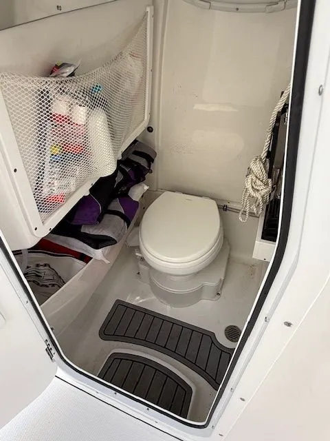 Slide: The Image of Interior of Sea Hunt Ultra 265 SE 2025 with toilet and storage. - 17