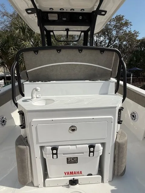 Slide: The Image of 2025 Sea Hunt Ultra 265 SE boat interior with sink and cooler. - 6