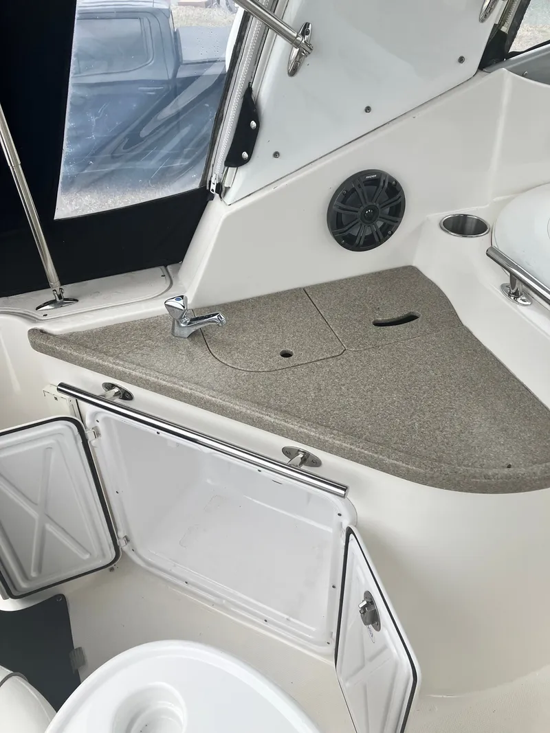 Slide: The Image of Interior of a 2008 Rinker 260 Express Cruiser with sink and storage. - 10