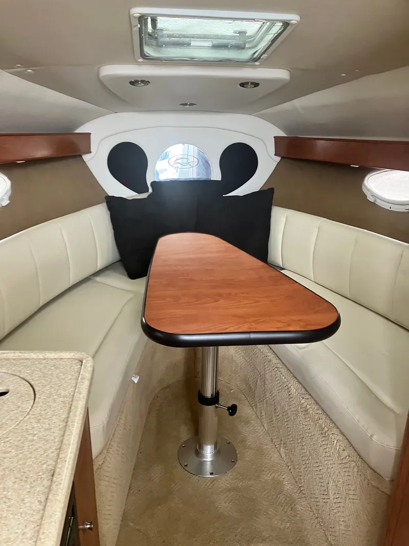 Slide: The Image of Interior of 2008 Rinker 260 Express Cruiser with table and seating area. - 4