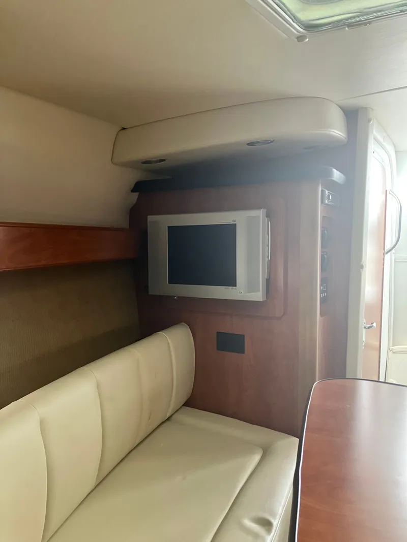 Slide: The Image of Interior of 2008 Rinker 260 Express Cruiser with TV and seating area. - 5