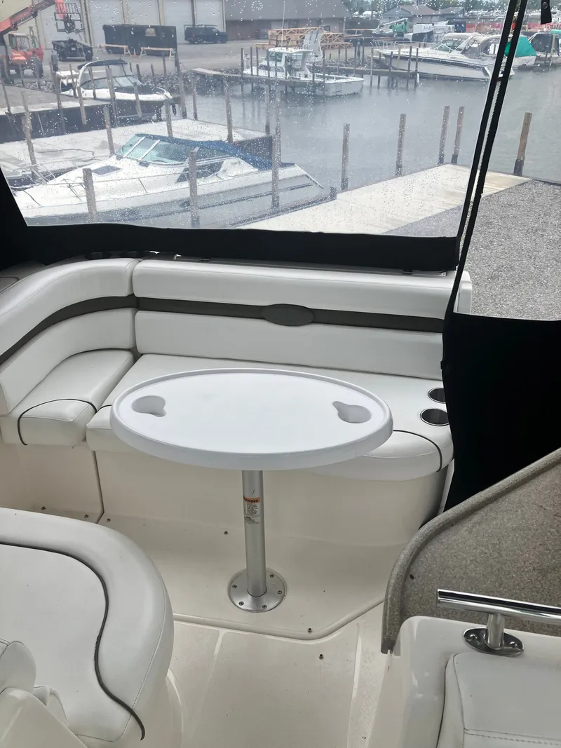 Slide: The Image of Interior of a 2008 Rinker 260 Express Cruiser with table and seating area. - 9