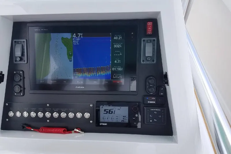 Slide: The Image of Control panel of 2017 Harrison Boatworks 28 Center Console with Garmin navigation display. - 11