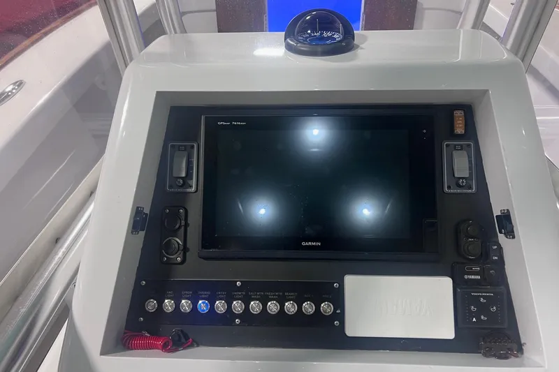 Slide: The Image of Control panel of 2017 Harrison Boatworks 28 Center Console with Garmin display and compass. - 13