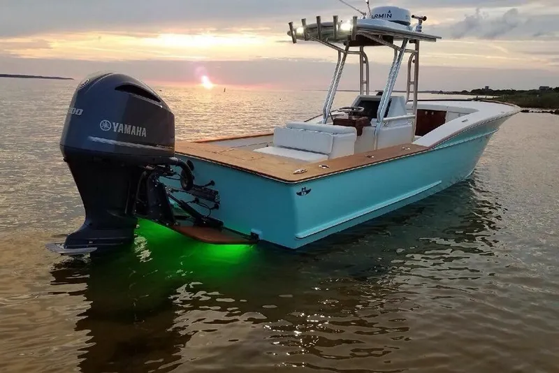 Slide: The Image of 2017 Harrison Boatworks 28 Center Console on water at sunset with Yamaha engine. - 2