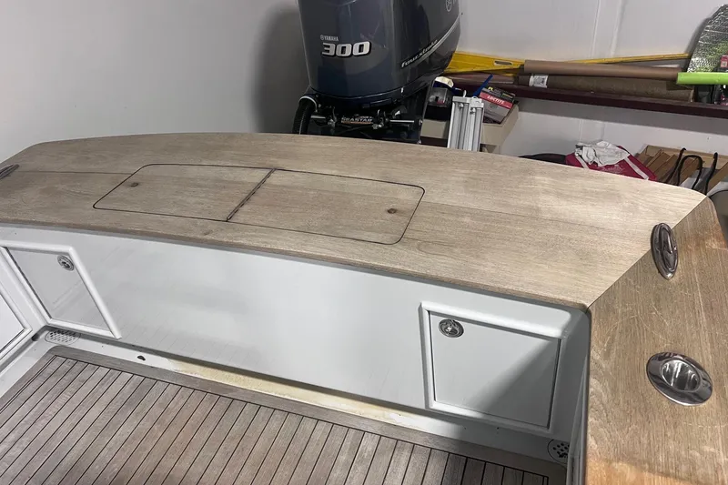 Slide: The Image of 2017 Harrison Boatworks 28 Center Console with Yamaha 300 engine, featuring wooden deck and storage compartments. - 23