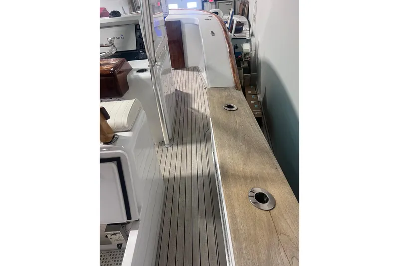 Slide: The Image of 2017 Harrison Boatworks 28 Center Console interior with wooden deck and modern equipment. - 24