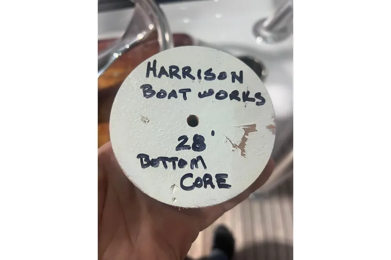 Slide: The Image of Hand holding a labeled core sample from a 2017 Harrison Boatworks 28 Center Console. - 27