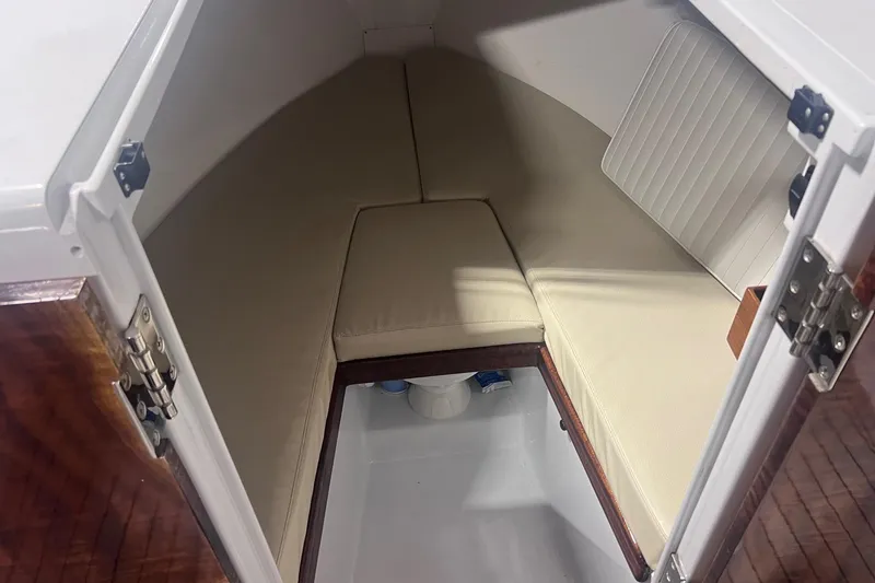 Slide: The Image of Interior cabin of 2017 Harrison Boatworks 28 Center Console with beige cushions. - 7