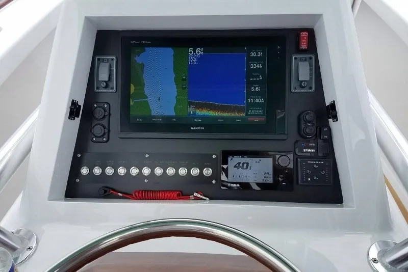 Slide: The Image of Control panel of a 2017 Harrison Boatworks 28 Center Console with navigation display. - 9