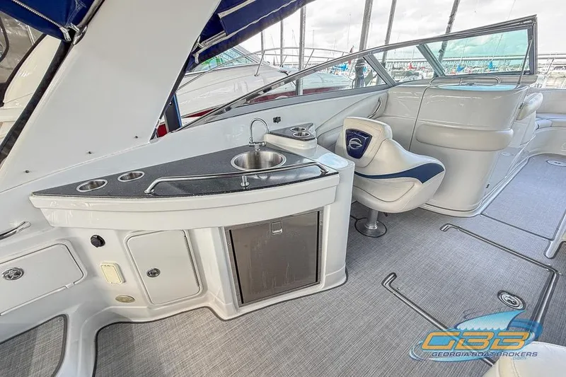 Slide: The Image of 2009 Crownline 300 LS boat interior with sink, seating, and modern amenities. - 10