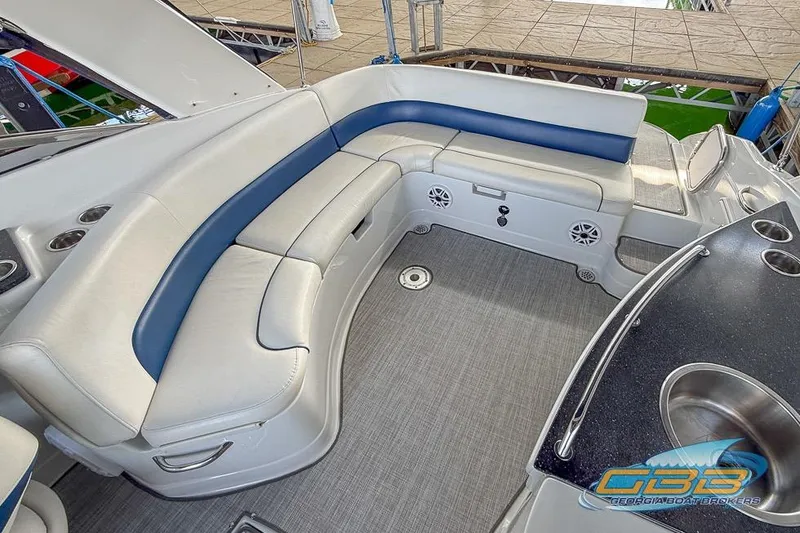 Slide: The Image of 2009 Crownline 300 LS boat interior with cushioned seating and sleek design. - 11