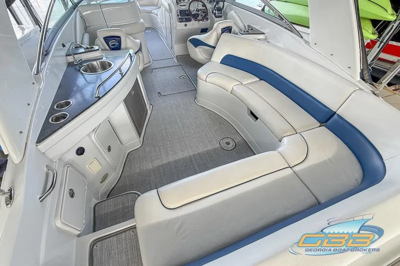 Slide: The Image of Interior of 2009 Crownline 300 LS boat with seating and kitchenette area. - 12