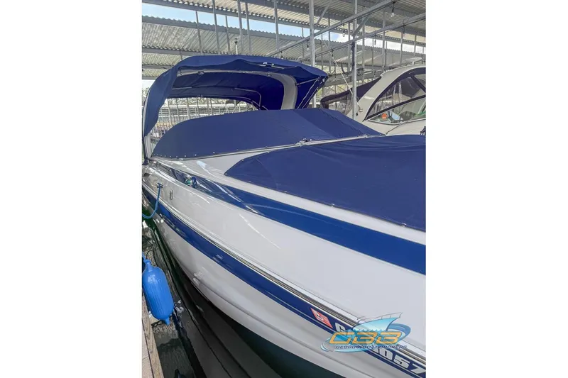 Slide: The Image of 2009 Crownline 300 LS boat with blue cover docked in marina. - 13
